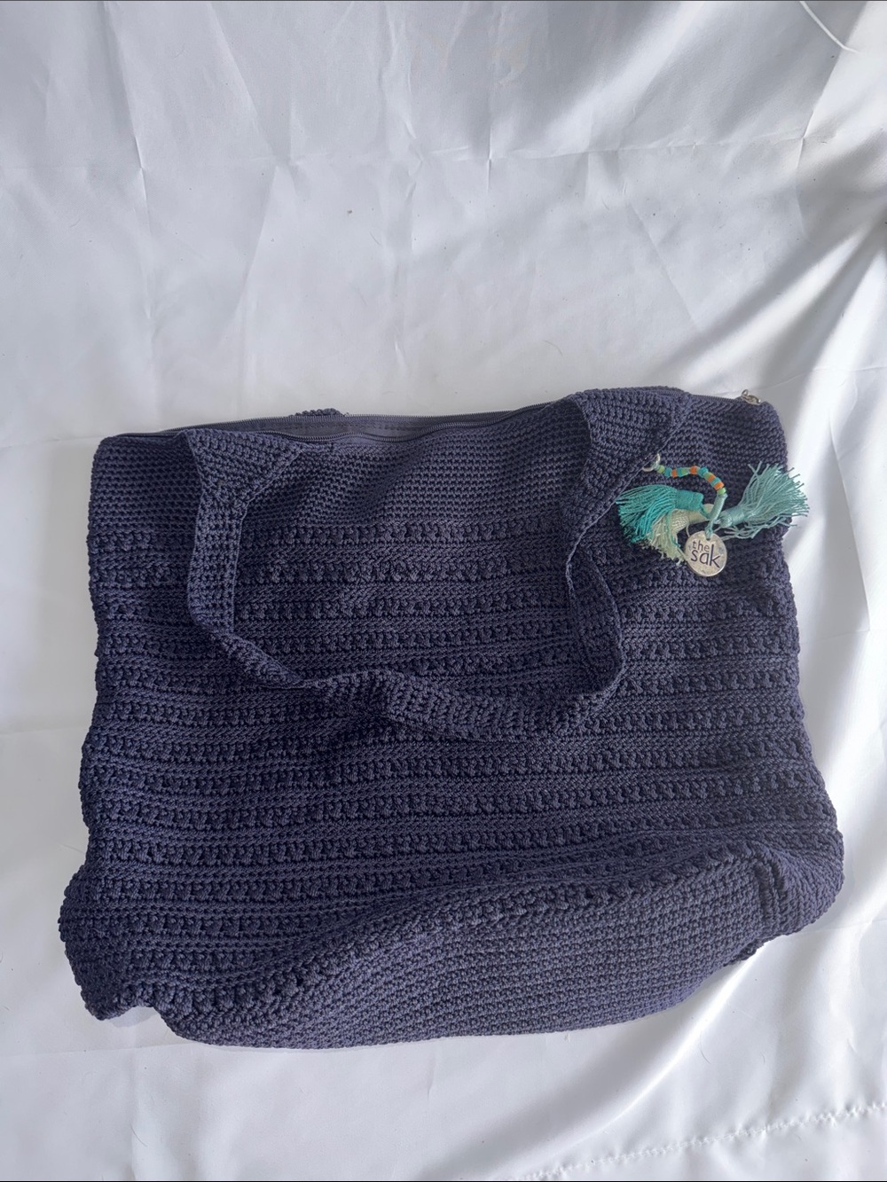 The Sak Navy Crochet Tote with Teal Tassel Charm